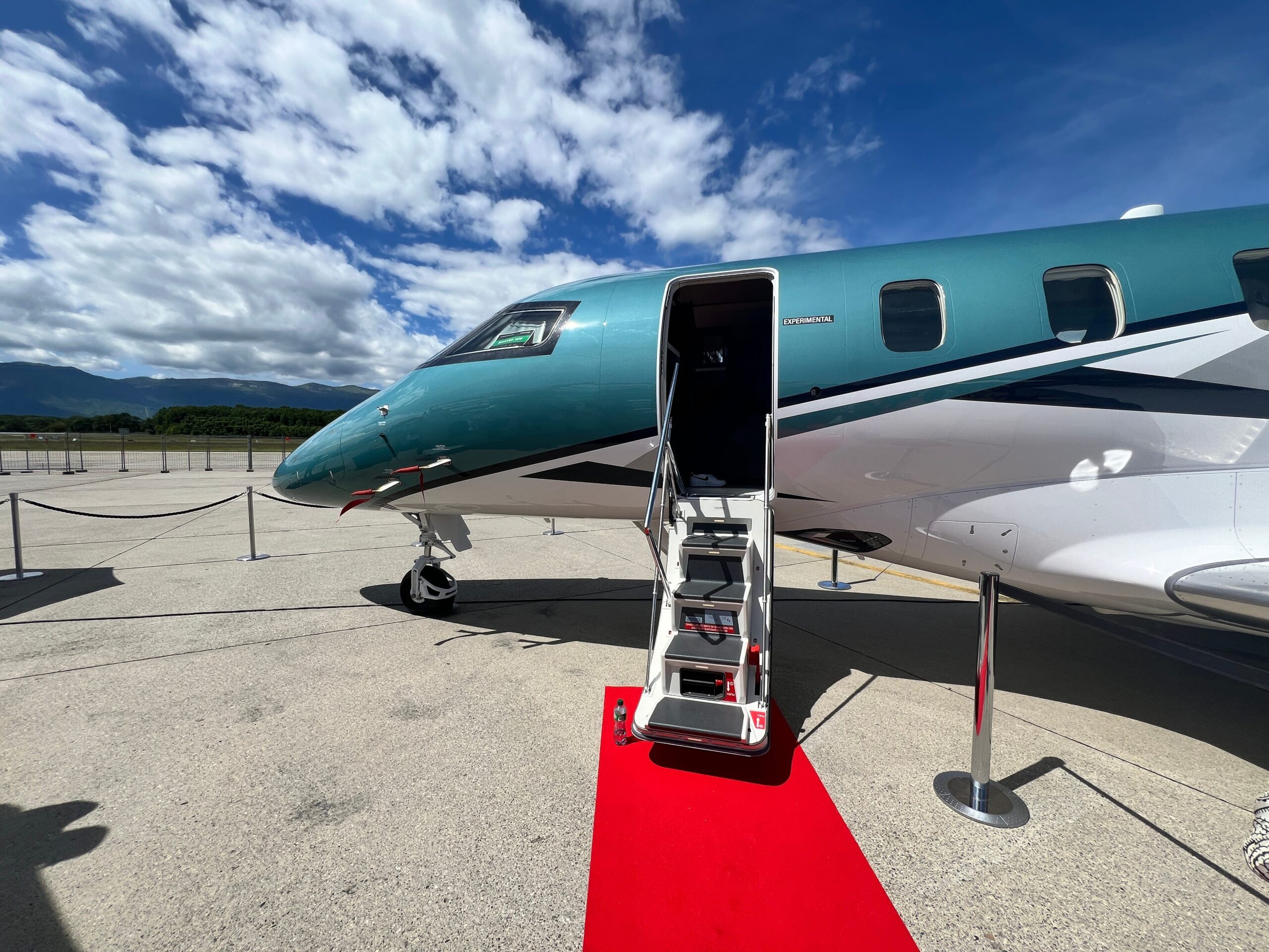 The front of a Pilatus PC-24 with a red carpet leading to the steps at EBACE 2024.