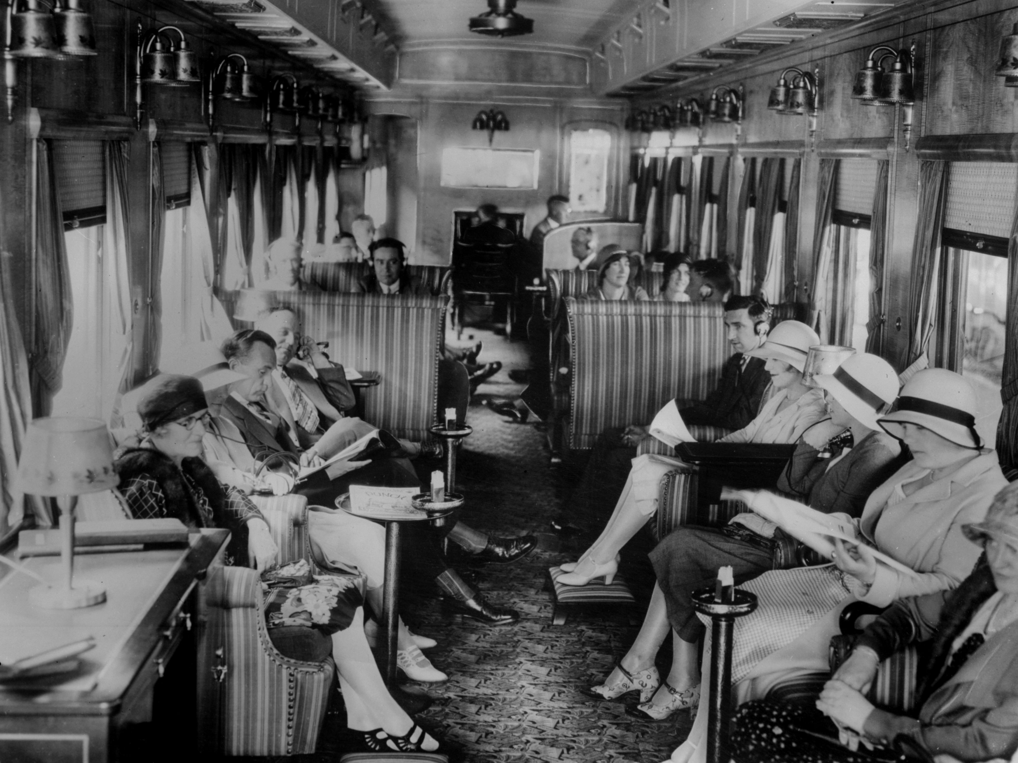 Passengers listen to the wireless on board a train on the Canadian Pacific Railway in 1930.