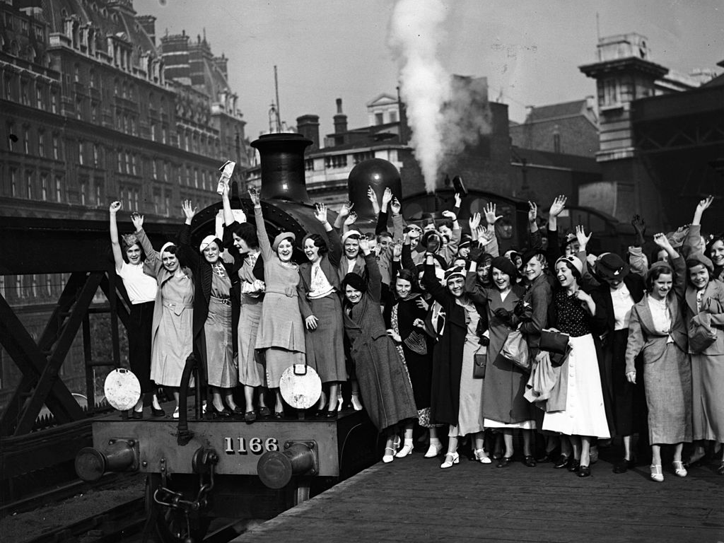 Employees of Messrs Carreras waving from the platform prior to departure from Charing Cross Station, London, in 1935.