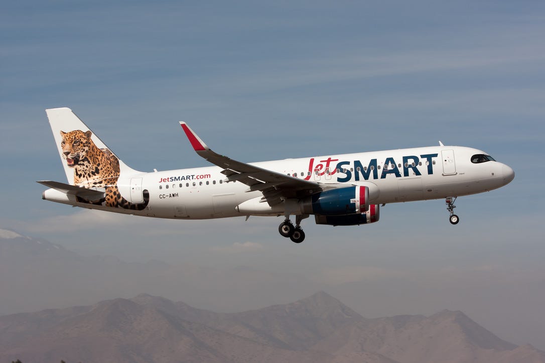 A white JetSmart plane with a picture of a cheetah on the tail.