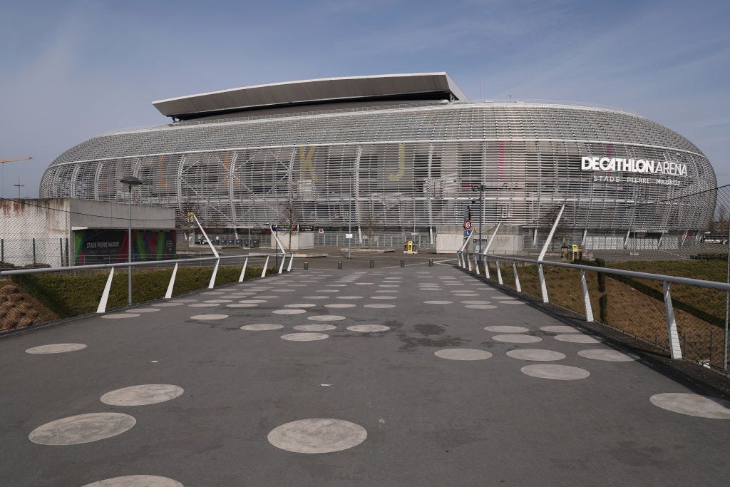 The Decathlon arena, Pierre Mauroy Stadium, is an oval-shaped building with a grated metal exterior.