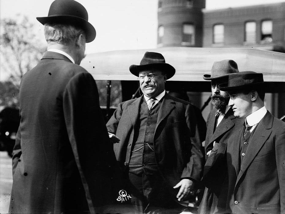 President Theodore Roosevelt smiles as he greets supporters