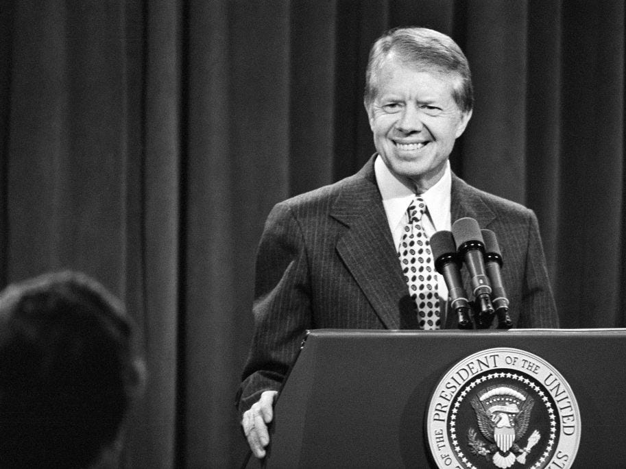 President Jimmy Carter speaks at a podium.