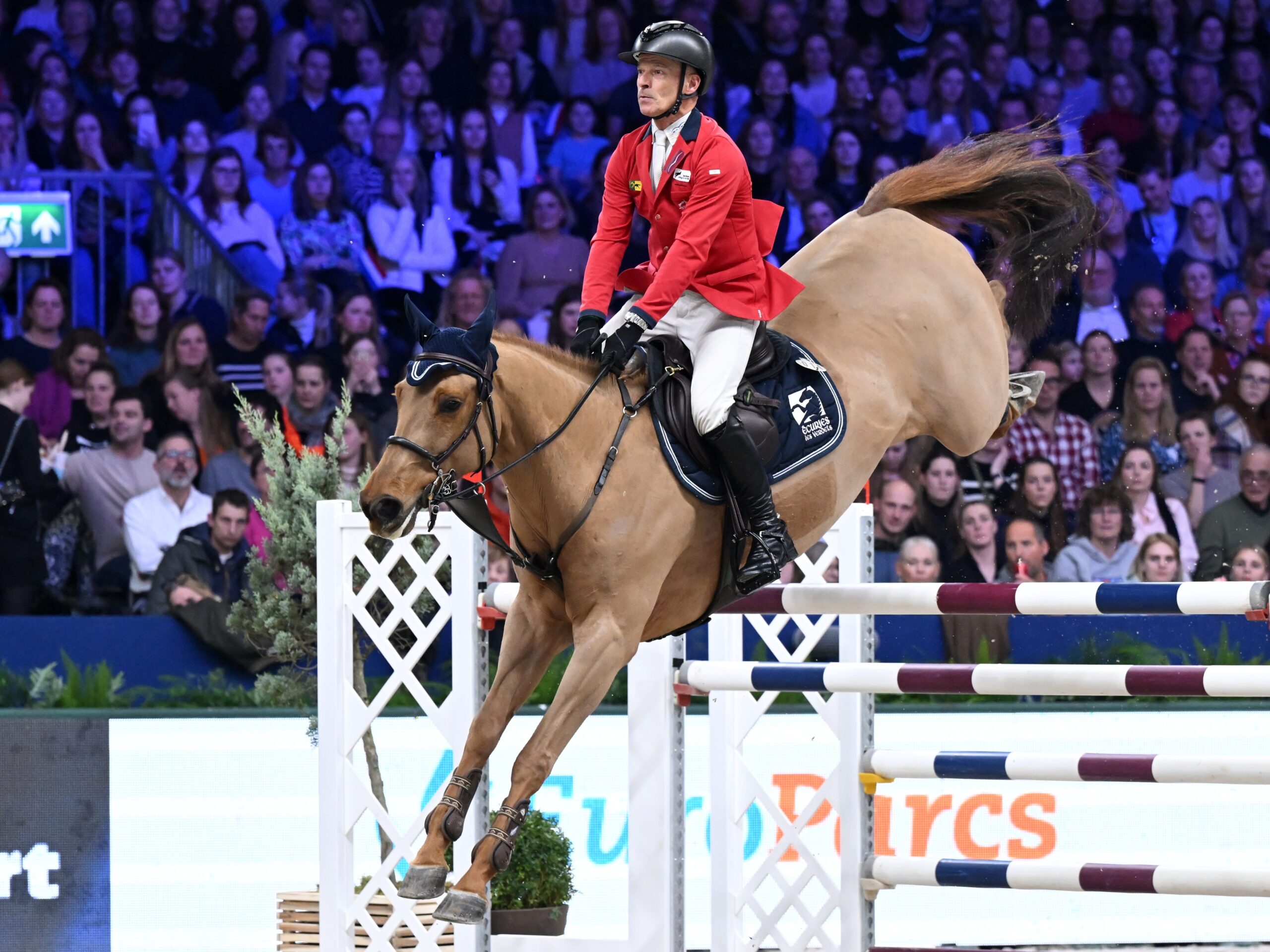 Pius Schwizer competing in a jumping equestrian event