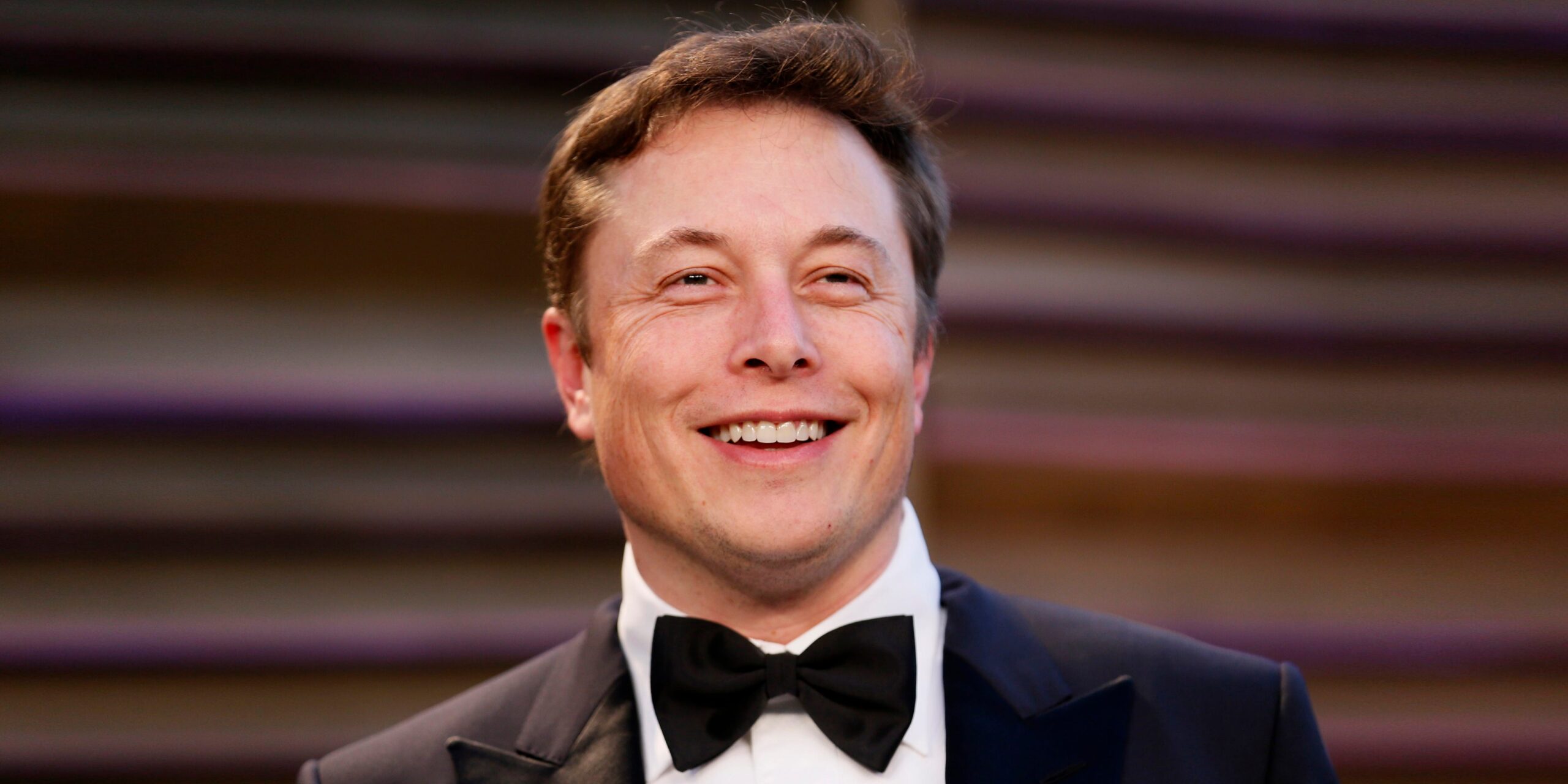 Elon Musk smiling.