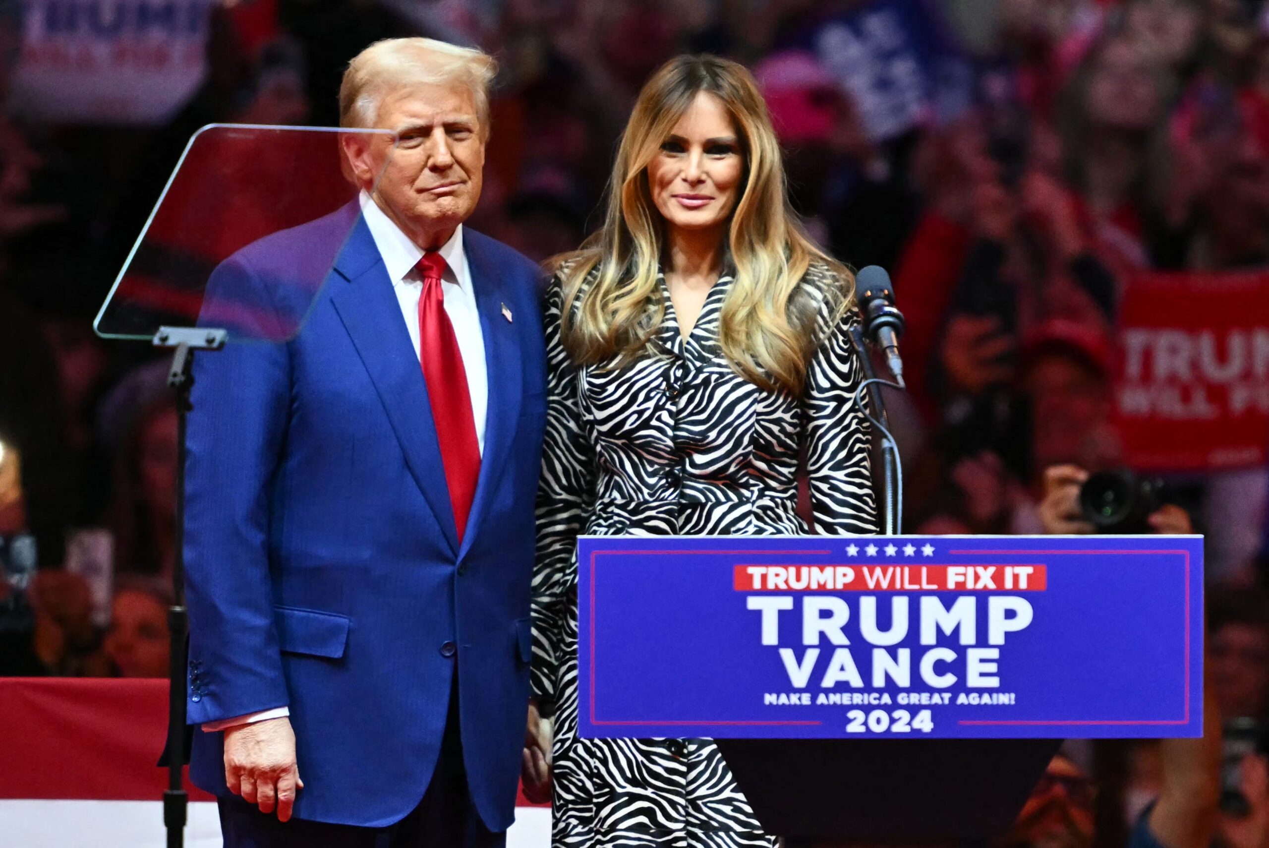 Former US President Donald Trump joins former First Lady Melania Trump onstage during a campaign rally.