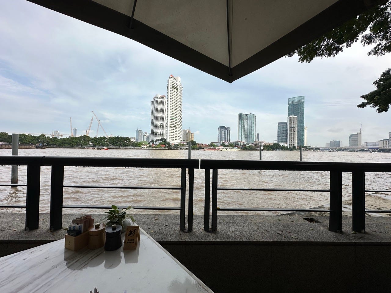 View of buildings across river with railing in front from breakfast