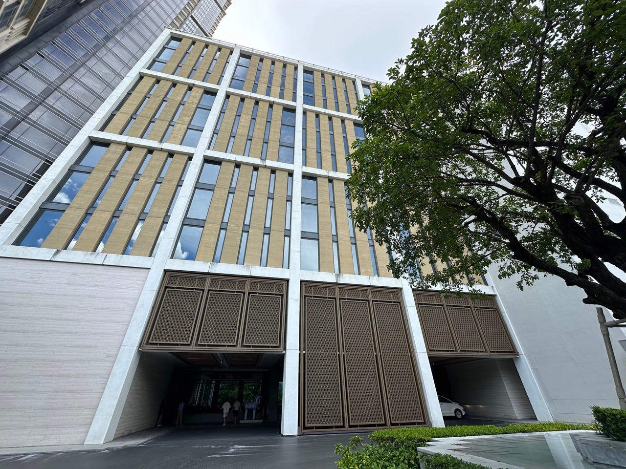 Four-story hotel with wood slats over windows in decorative fashion