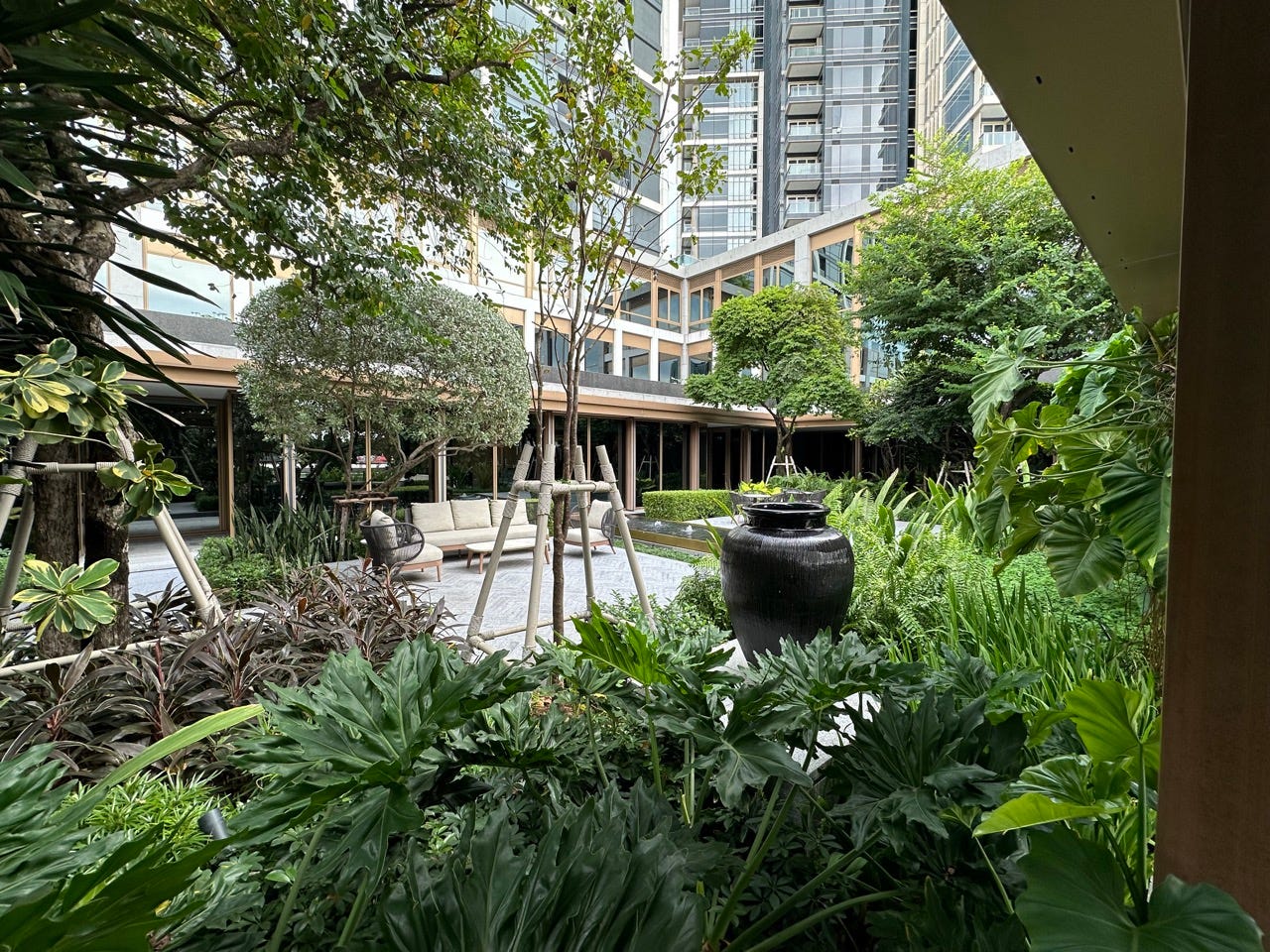 Trees in front of hotel building with a lot of windows 