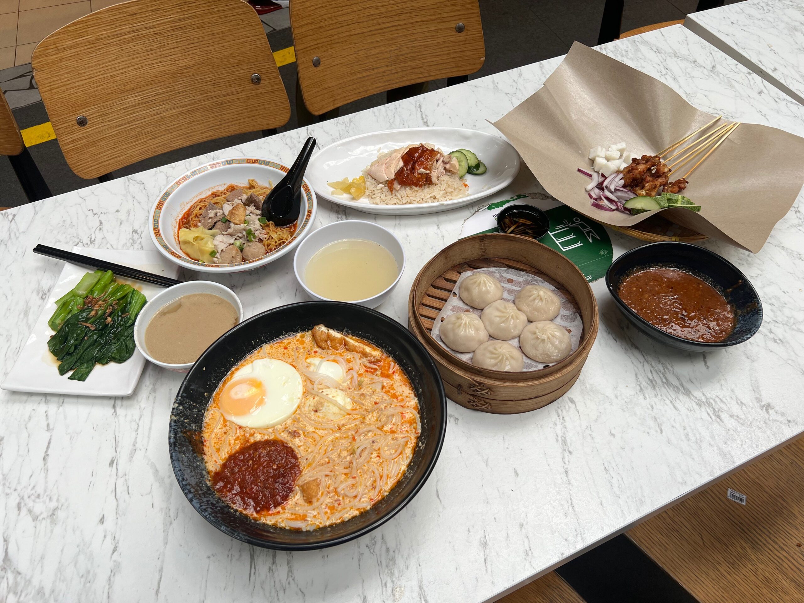 The feast of food I ordered from different shops in the Singapore food street.