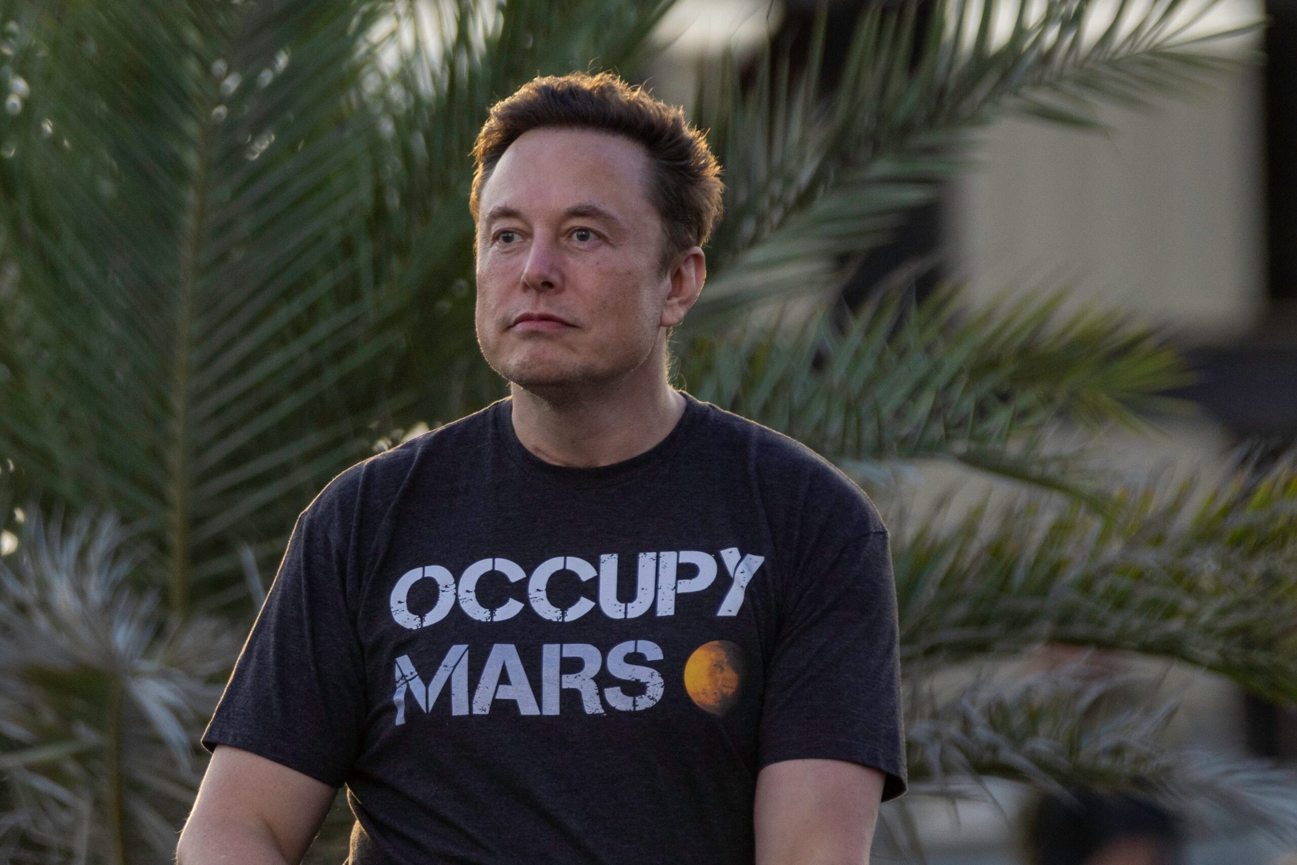 SpaceX founder Elon Musk wears a black shirt which says 'Occupy Mars.'