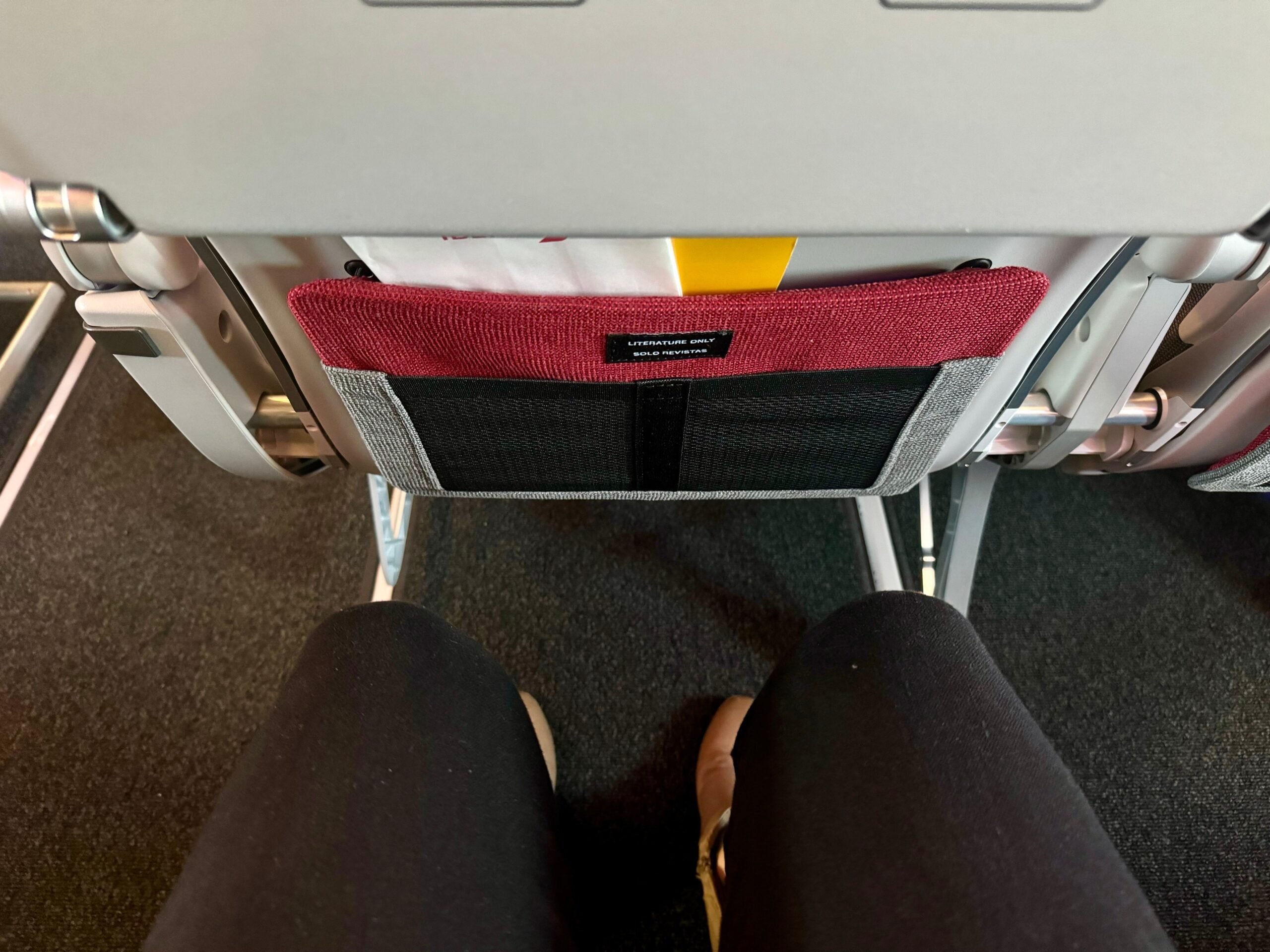 The author showing the legroom in Iberia A321XLR regular coach.