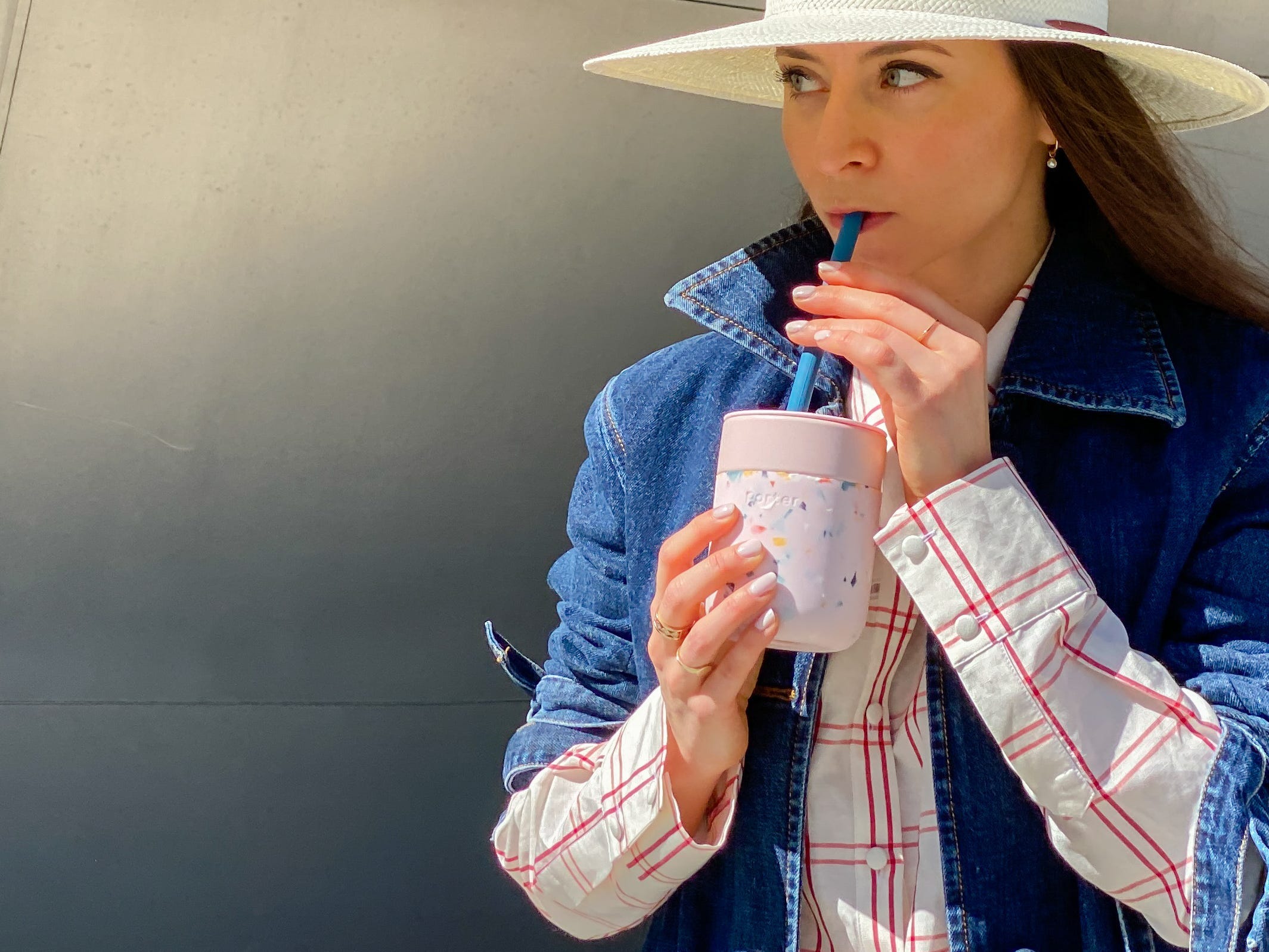 A person sips out of a reusable straw.