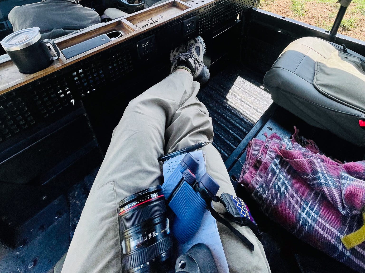 Binoculars in the author's lap on safari.