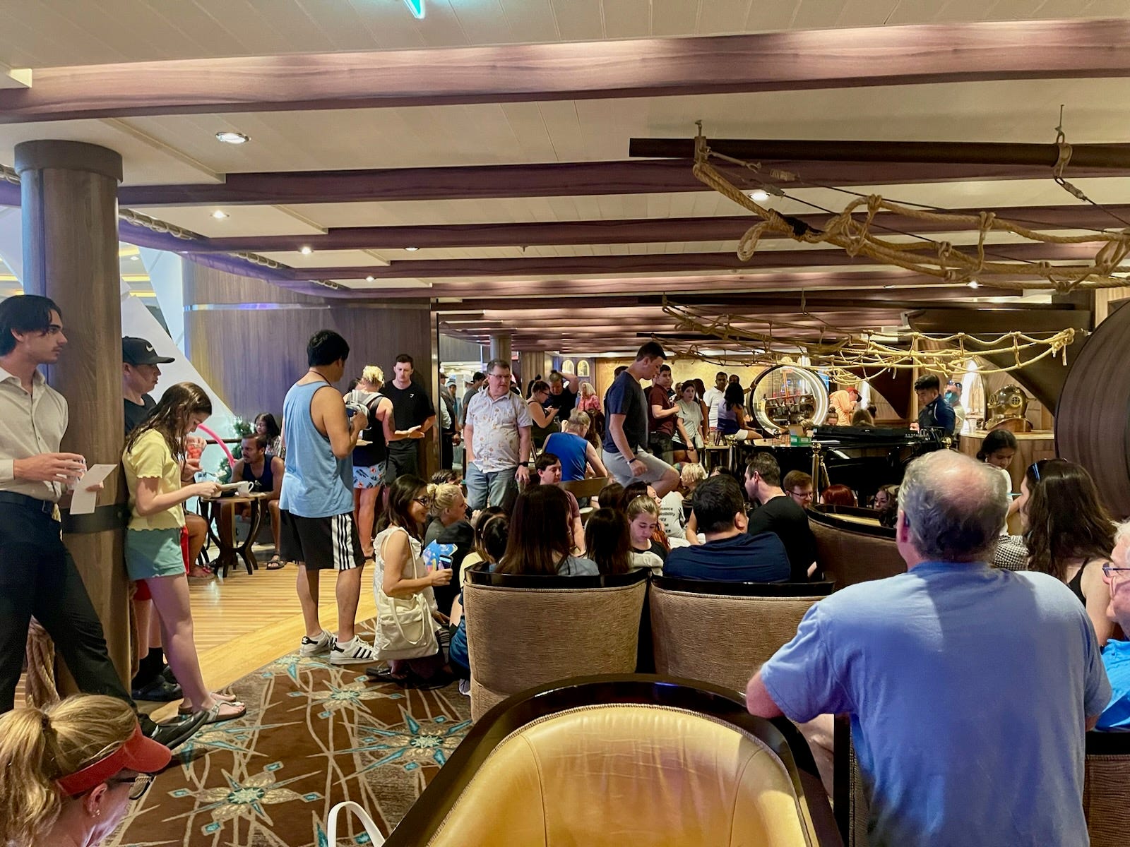 Crowds of people at a trivia event on a cruise ship