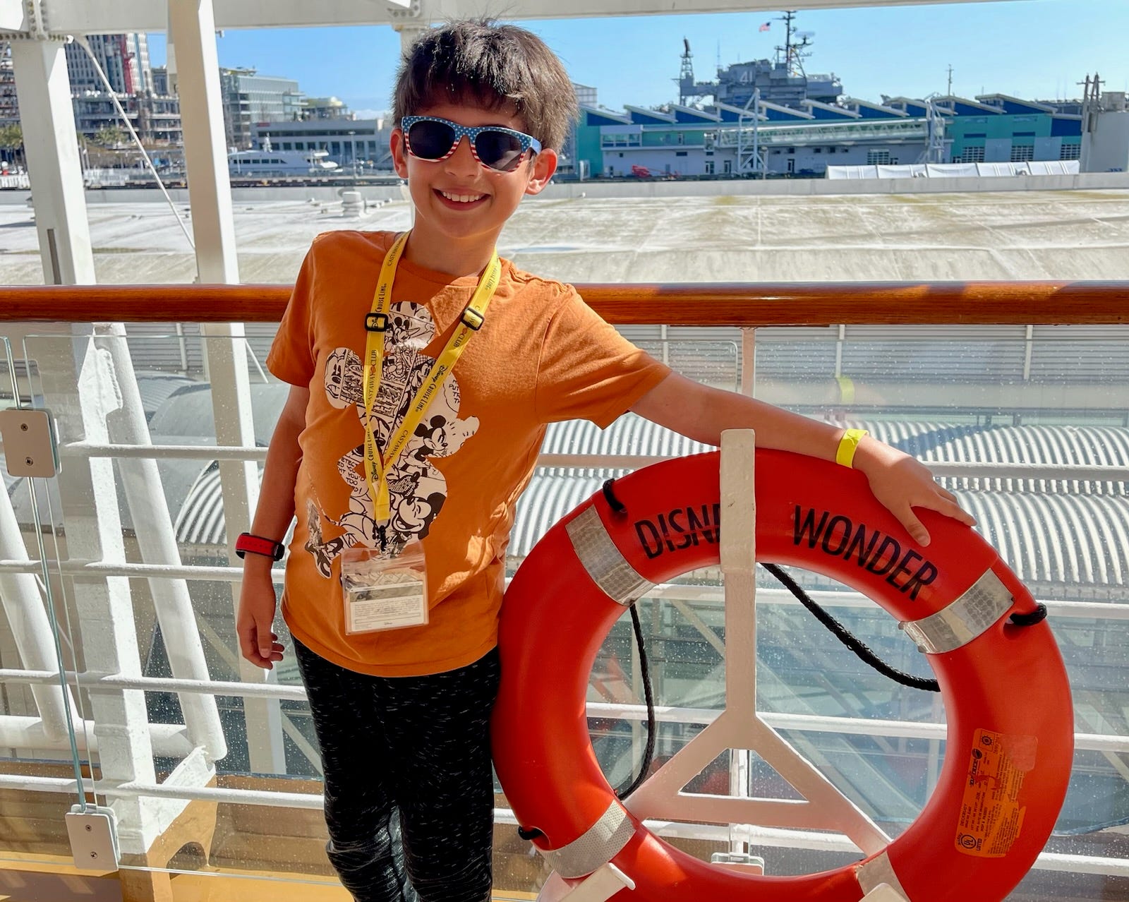 Author Amanda Adler's son smiling while holding Disney Wonder life preserver