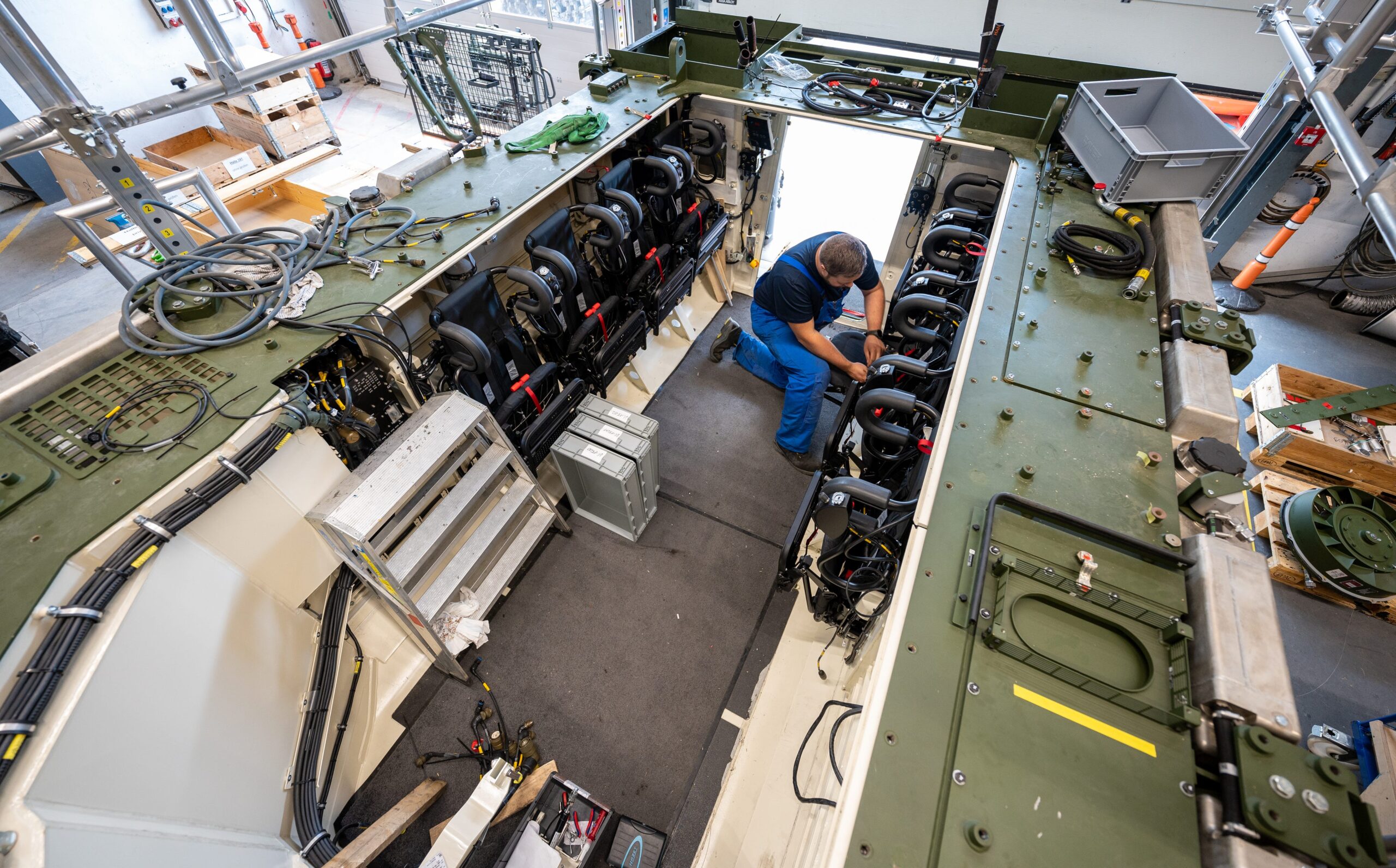 An employee works on the Lynx infantry fighting vehicle in Rheinmetall's production facility.