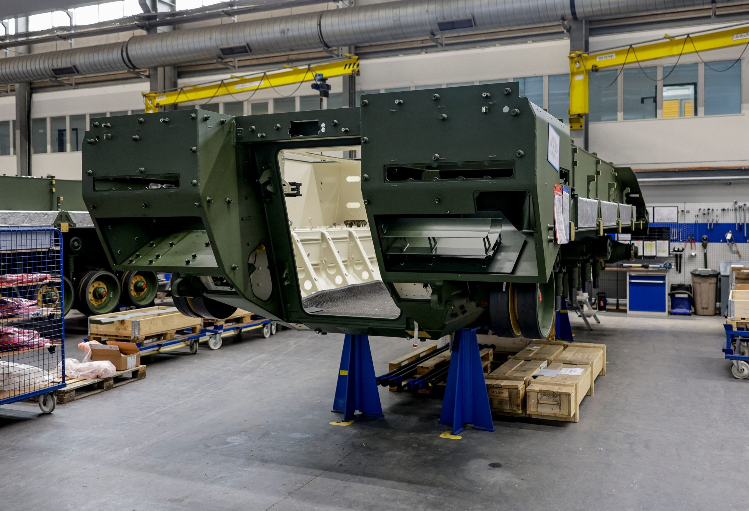 A Lynx infantry fighting vehicle is painted green at a Rheinmetall facility in Germany.