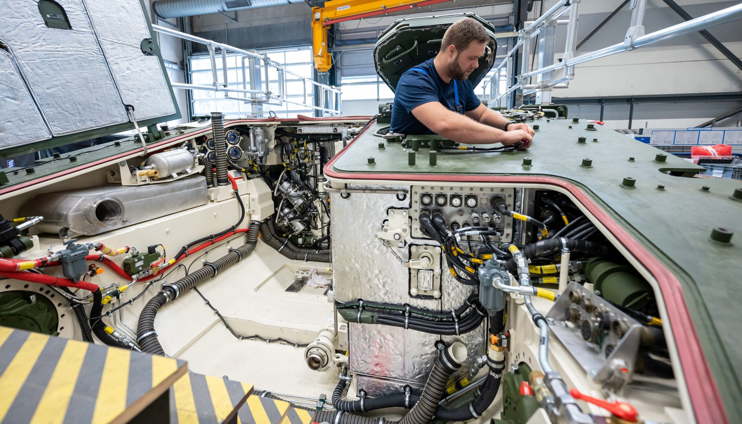 A Rheinmetall employee works on the Lynx infantry fighting vehicle in production.