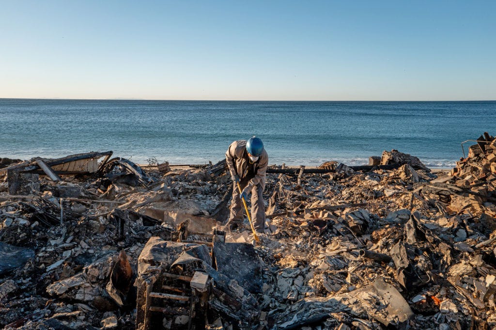 Patrick O'Neal sifts through his home after it was destroyed by the Palisades wildfire on January 13, 2025 in Malibu, California.