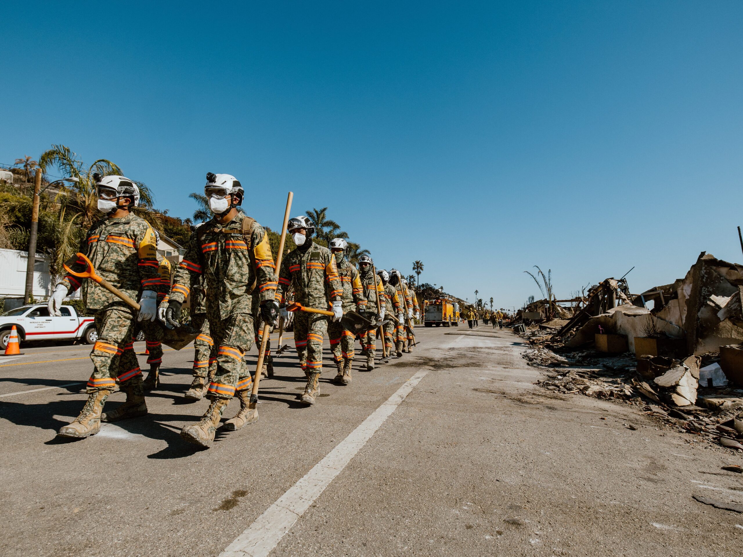 Members of the Mexican Army rescue team carried cleanup equipment as they marched along the Pacific Coast Highway on January 14, 2025.