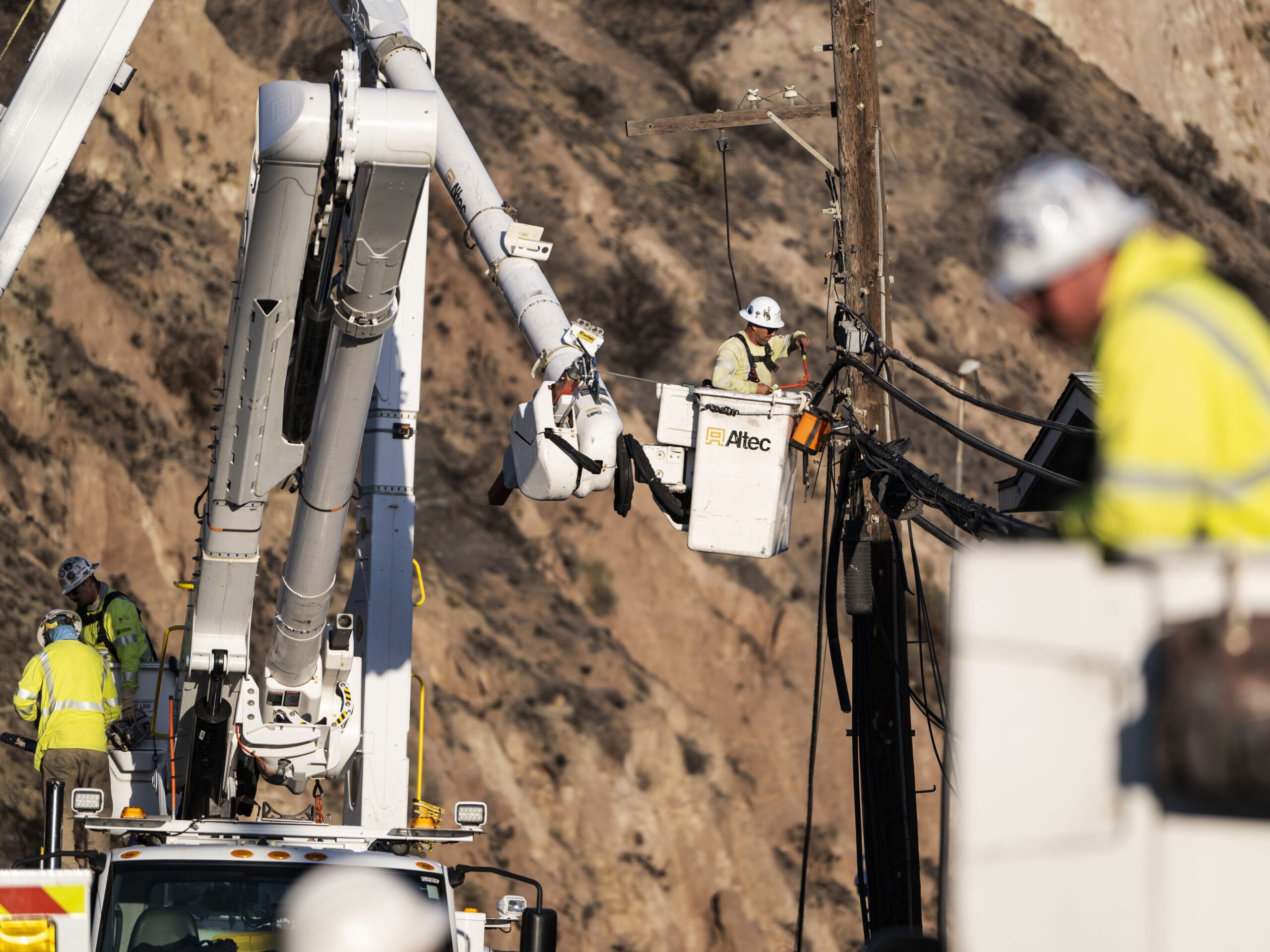 Workers for Southern California Edison disassembled burned power lines.