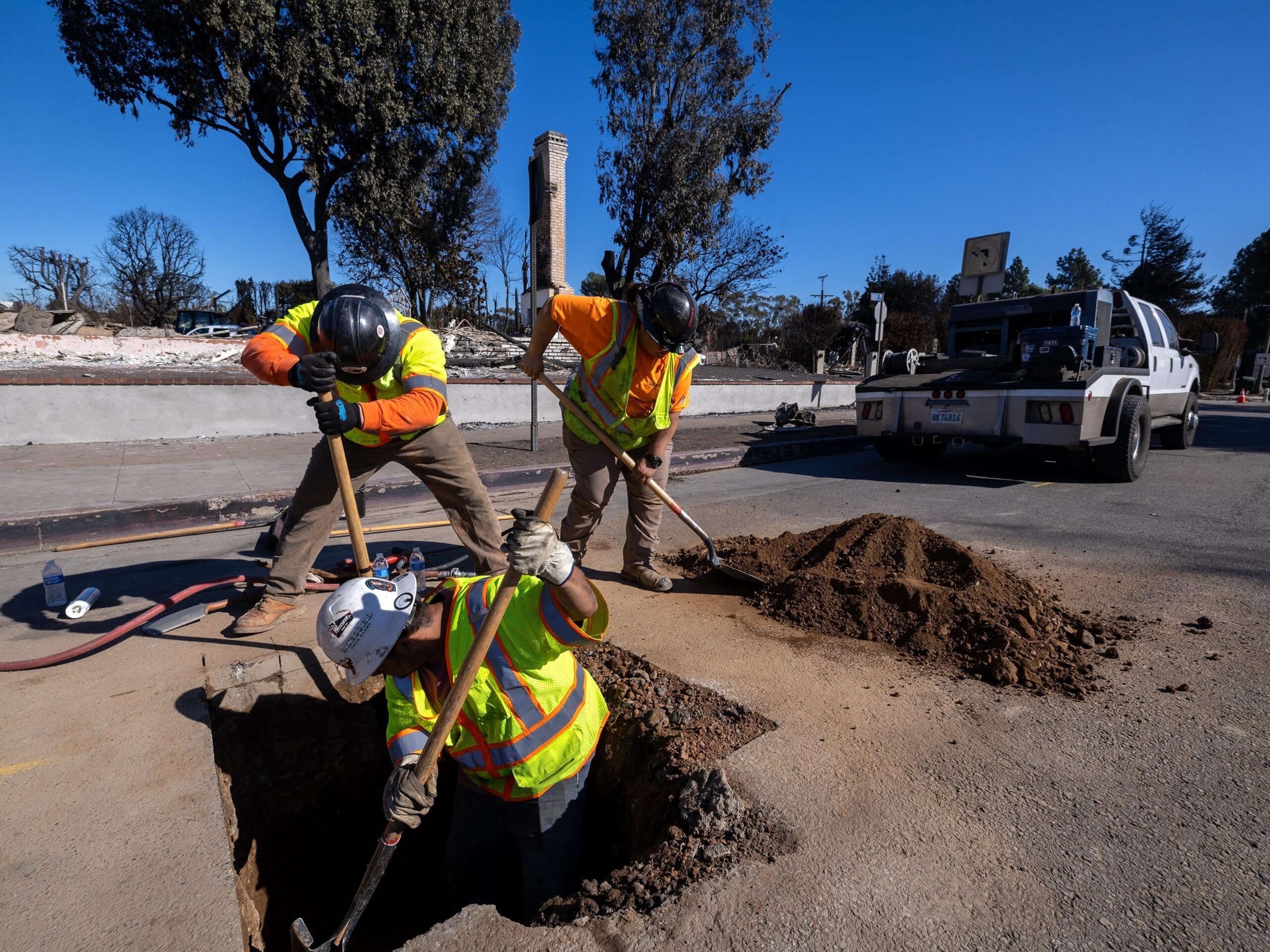 Three Southern California Gas Company contractors, Eric Martinez, Steven Orozco, and Kaylani Iafeta, wore safety vests as they dug to secure gas lines on Sunset Blvd.