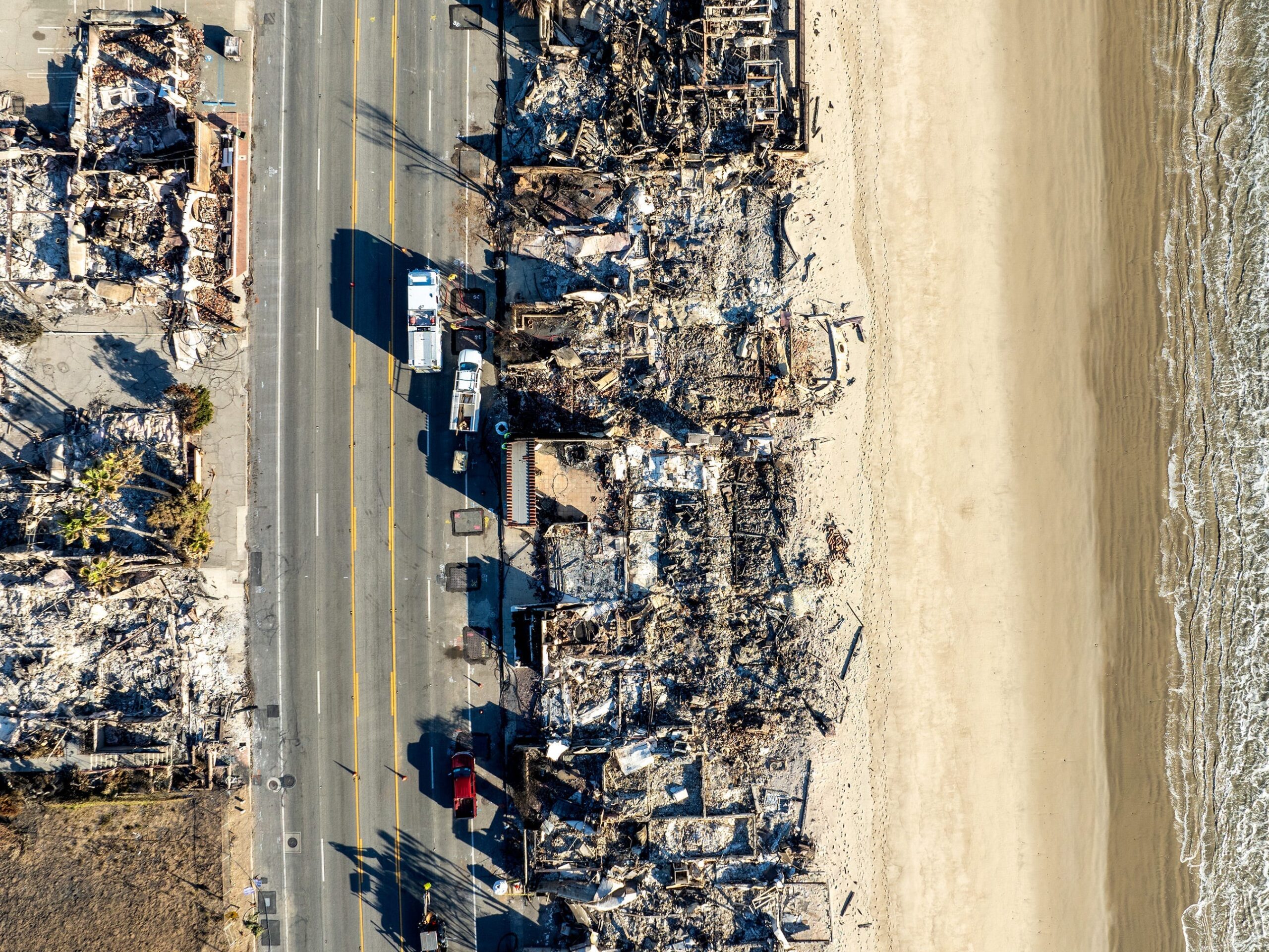 An aerial drone image of the effects of the Palisades fire, highlighting homes along the Pacific Coast Highway and Malibu Beach.