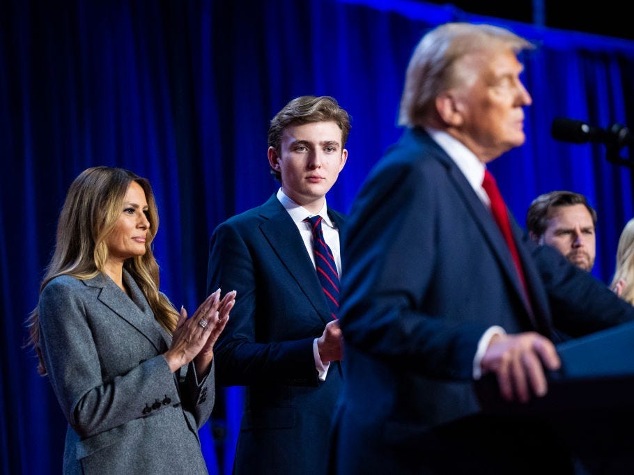 Barron Trump watches Donald Trump speak as Melania Trump looks on.