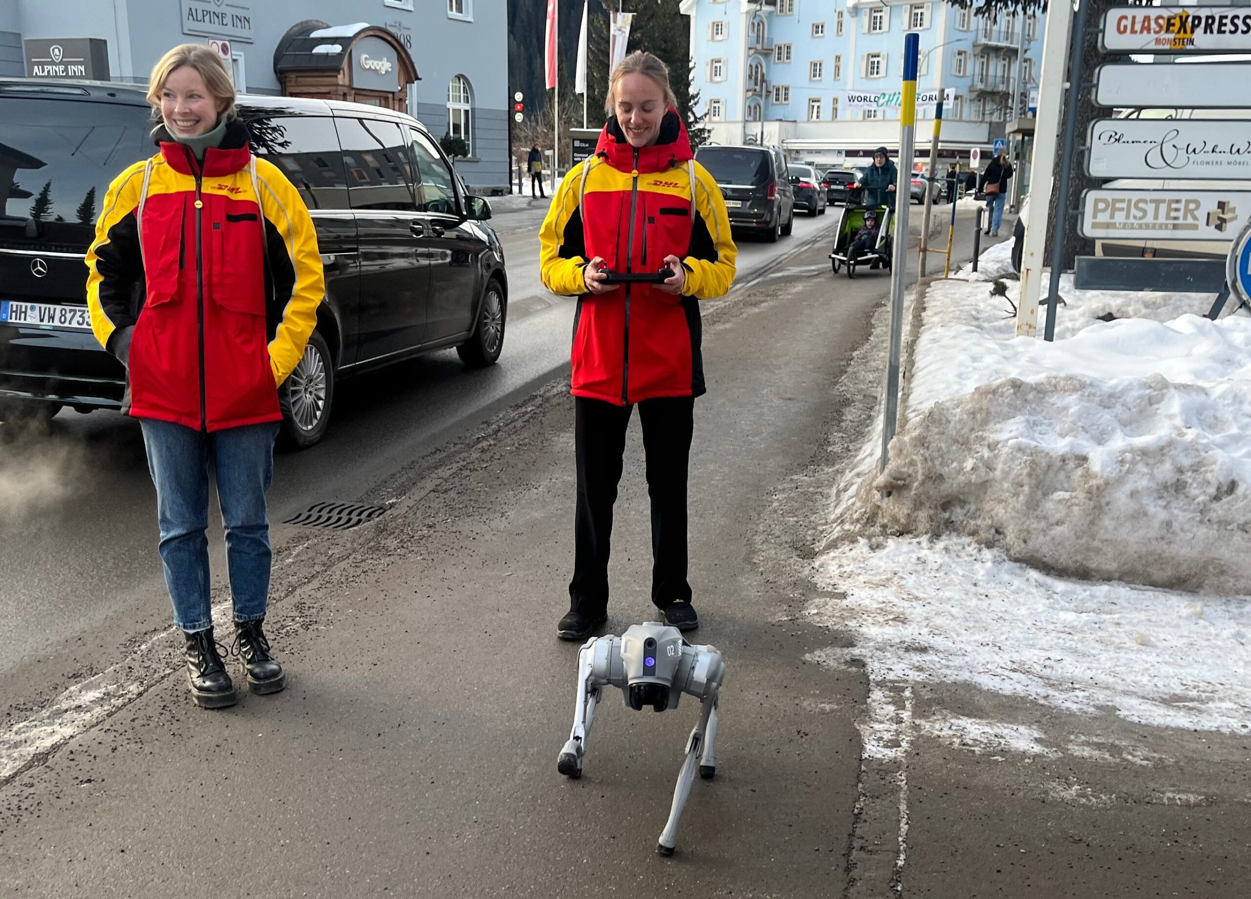 Two women controlling a walking robot