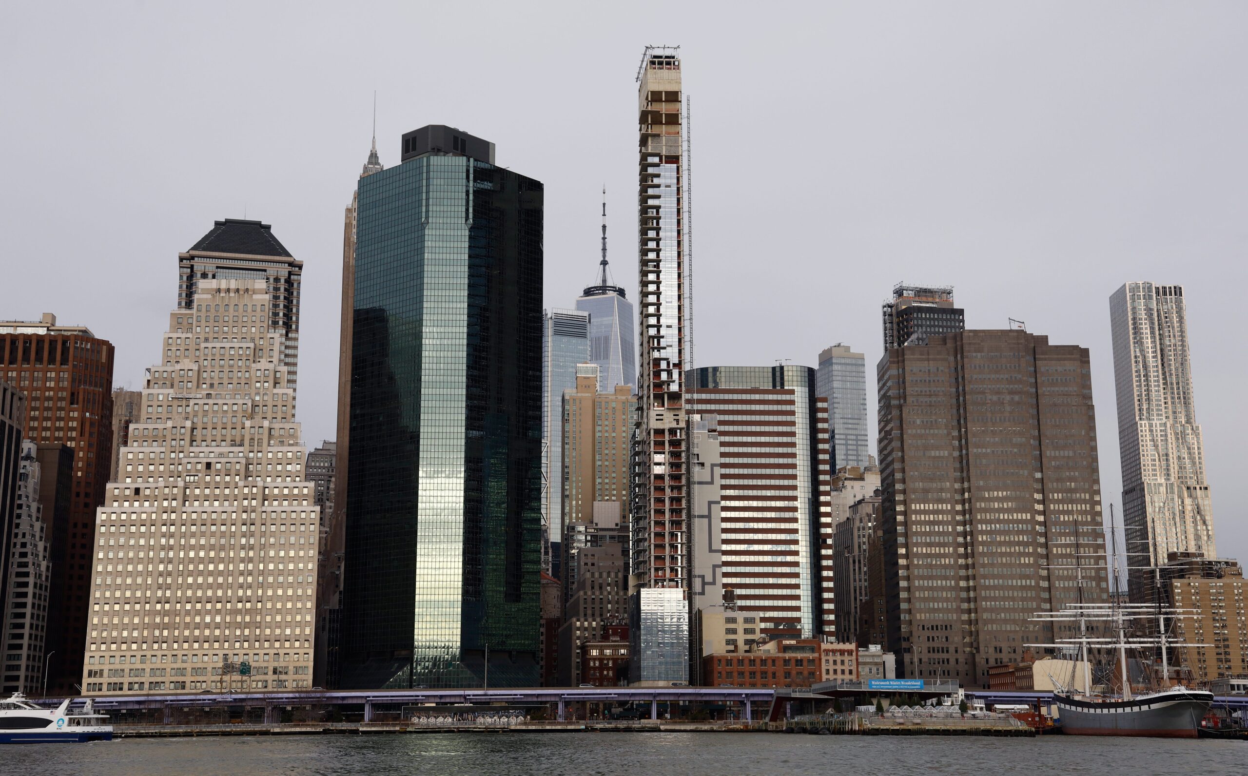 An tall, thin unfinished skyscraper among other buildings in New York City