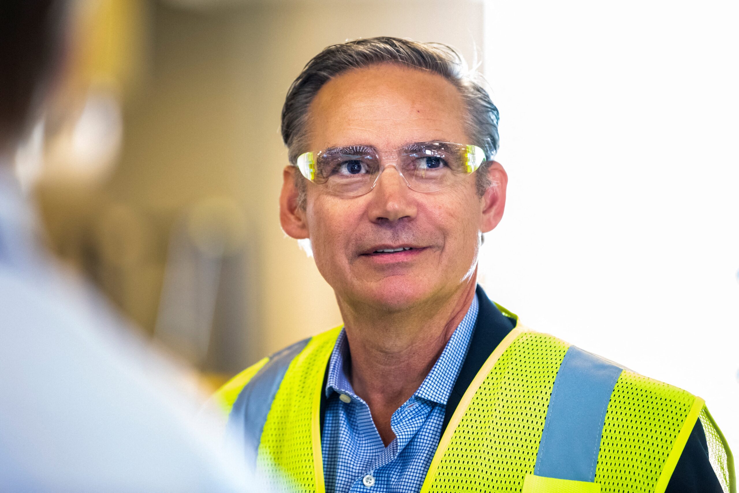 Kelly Ortberg wearing a high-vis vest and protective goggles.
